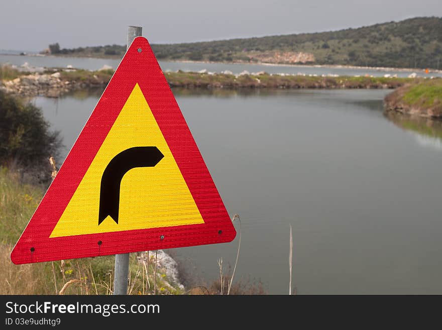 Traffic sign pointing right to a canal !