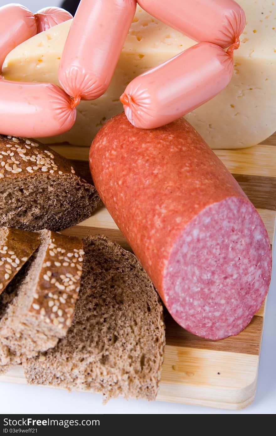 Bread and sausages on a white background