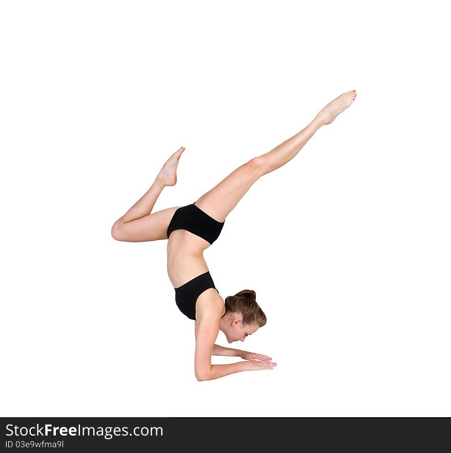 Beautiful young woman balancing on her forearms pointing her feet in the air. Beautiful young woman balancing on her forearms pointing her feet in the air