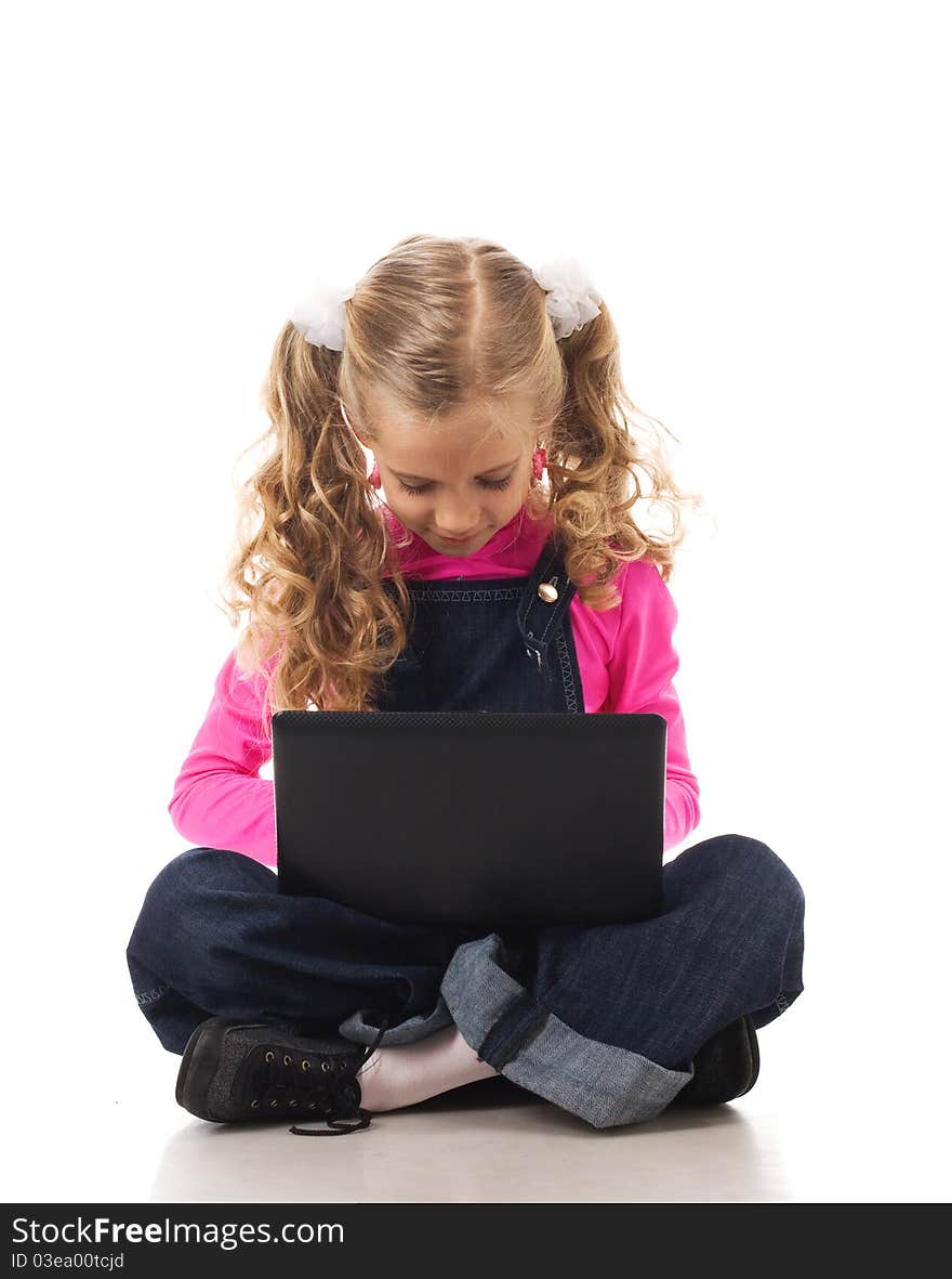 Young girl typing something on her own laptop. Young girl typing something on her own laptop