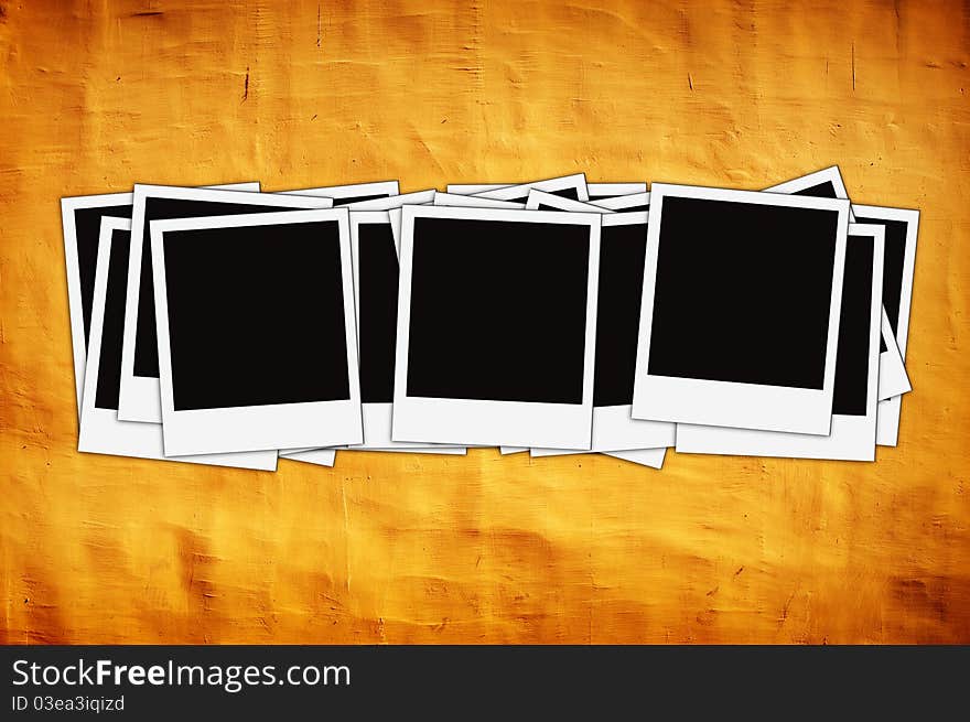 Stack of instant photos on vintage yellow wall with artistic shadows added