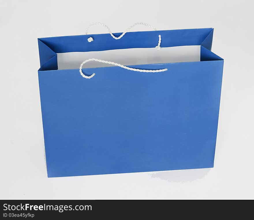 Blue package for purchases in shop on a gray background. Blue package for purchases in shop on a gray background