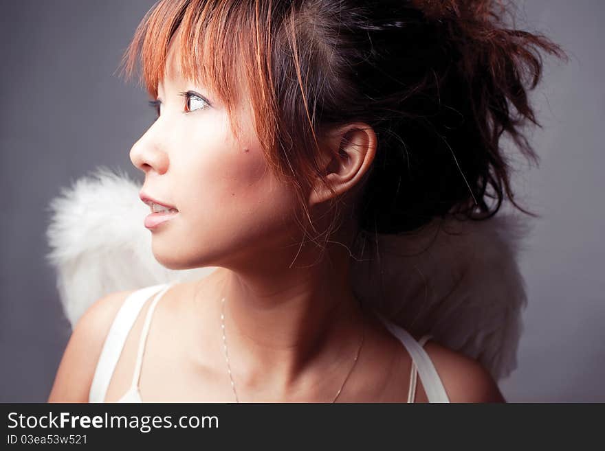 Girl wearing a white top with wings. Girl wearing a white top with wings.