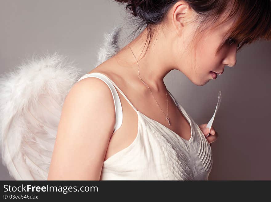 Girl wearing a white top with wings. Girl wearing a white top with wings.