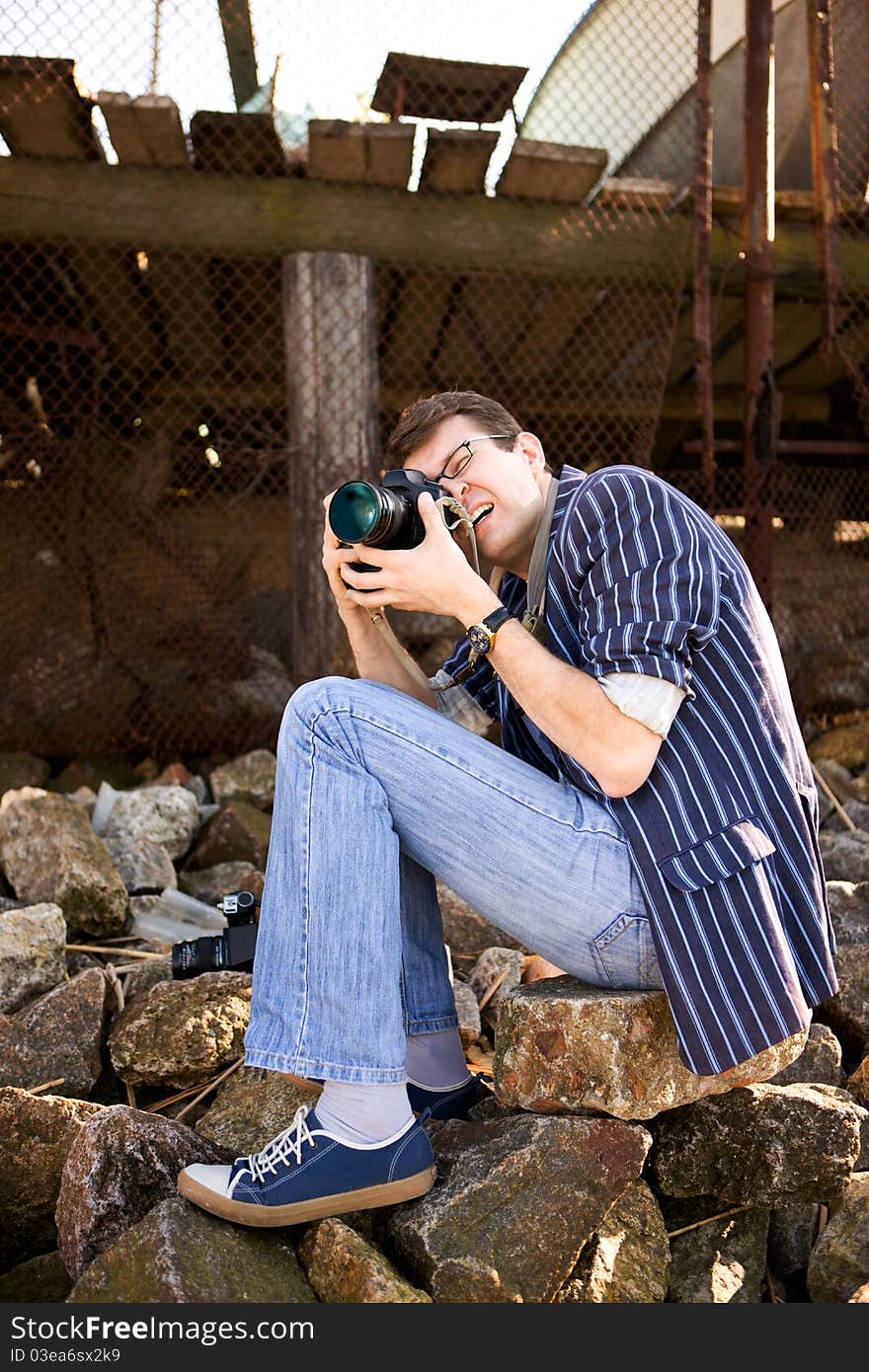 Photographer work with camera on sea bank