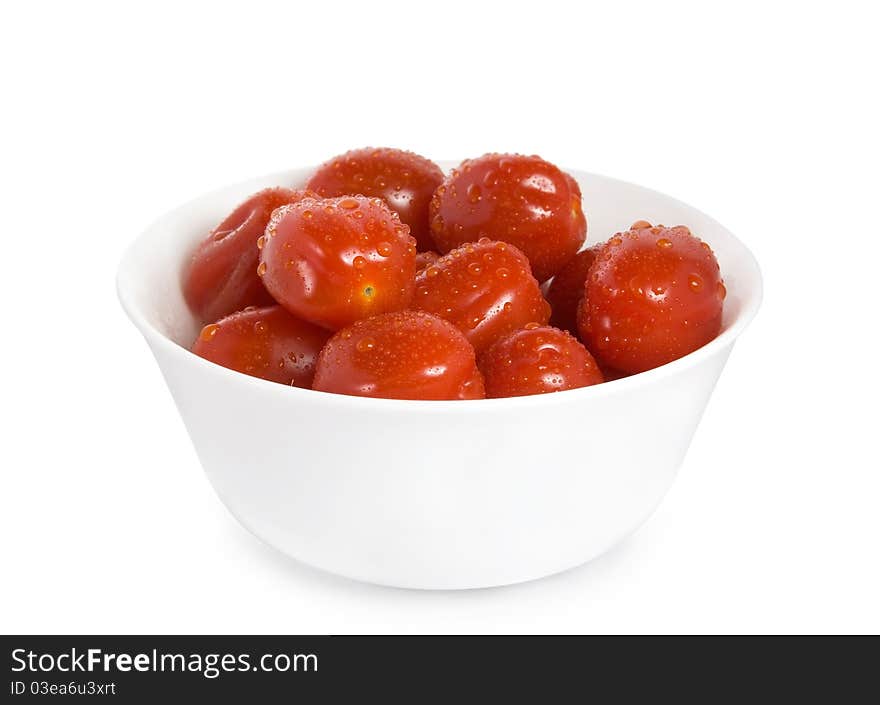 Red cherry tomatoes in the white bowl isolated on white