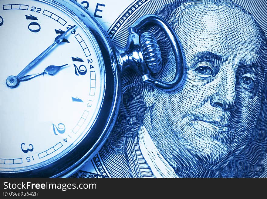 Old clock on the background of the portrait of Franklin at the hundred dollar bill. Old clock on the background of the portrait of Franklin at the hundred dollar bill