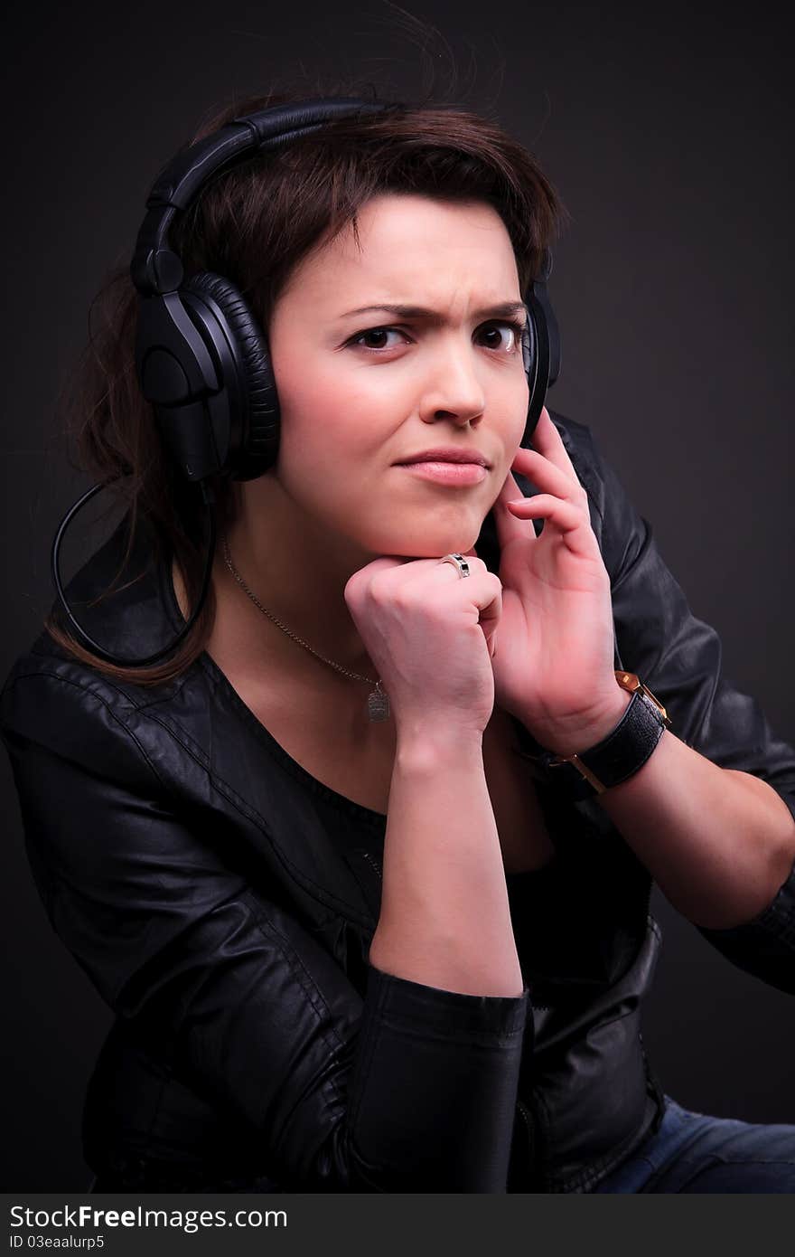 The beautiful young brunette girl in headphones. The beautiful young brunette girl in headphones