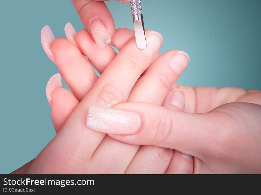 Manicure process with professional tools on female hand