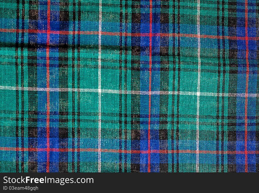 Close photo of squared colourful cloth, may be used as background. Close photo of squared colourful cloth, may be used as background