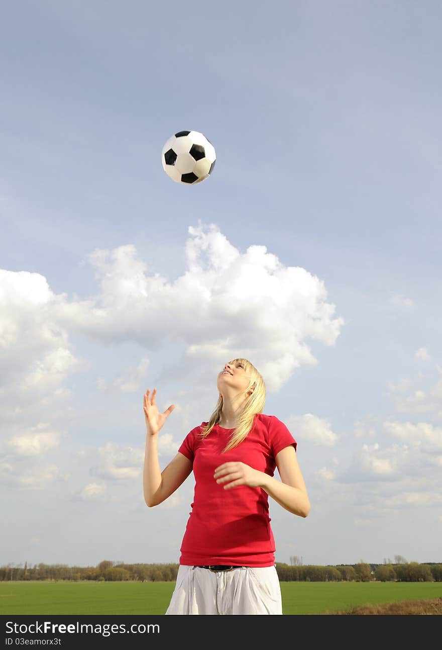 Young woman playing with soccer ball