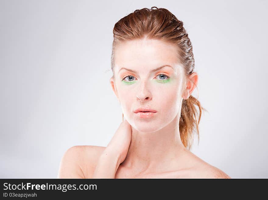 Beautiful young red-haired woman looking at camera