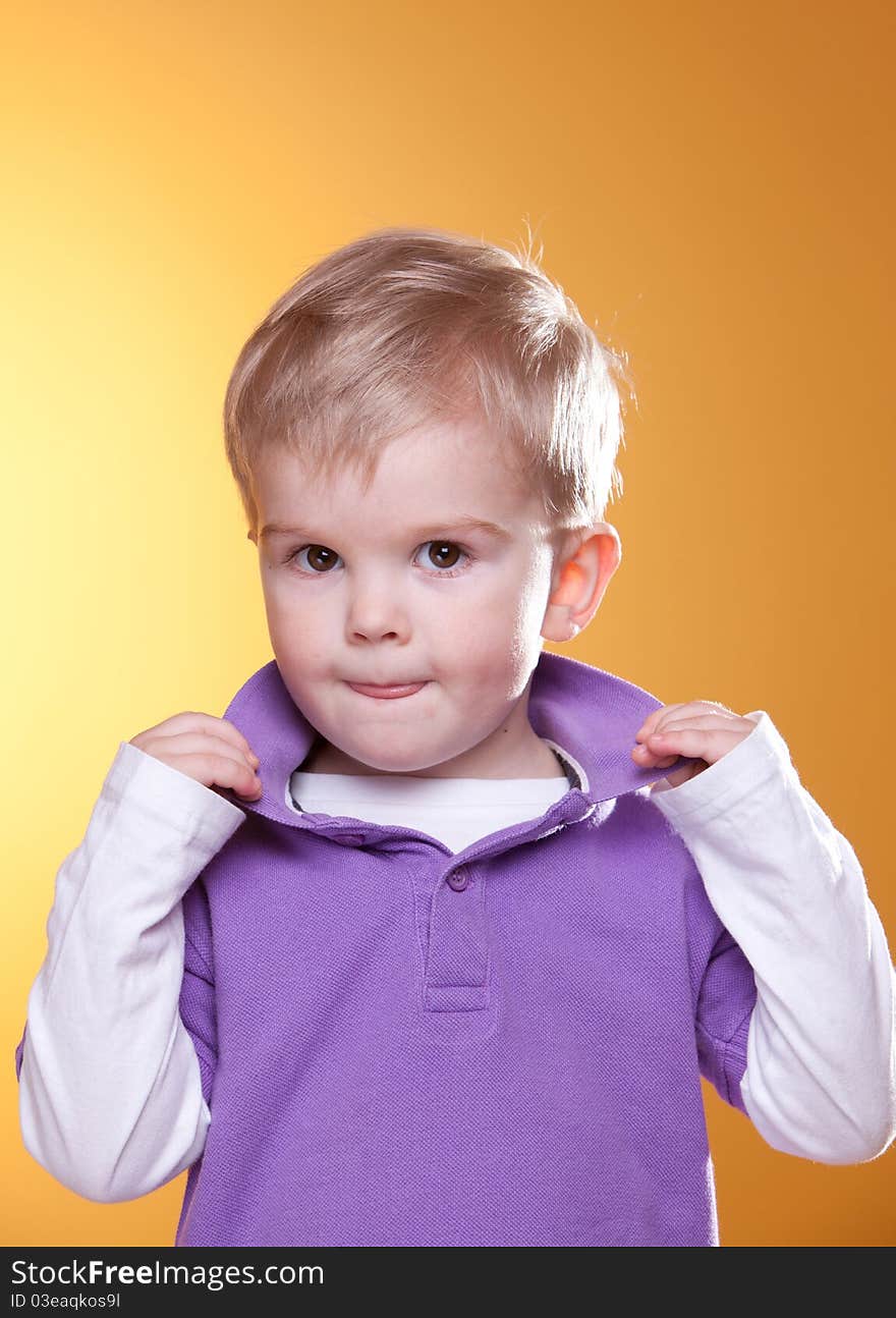 Cute blonde boy posing looking at camera