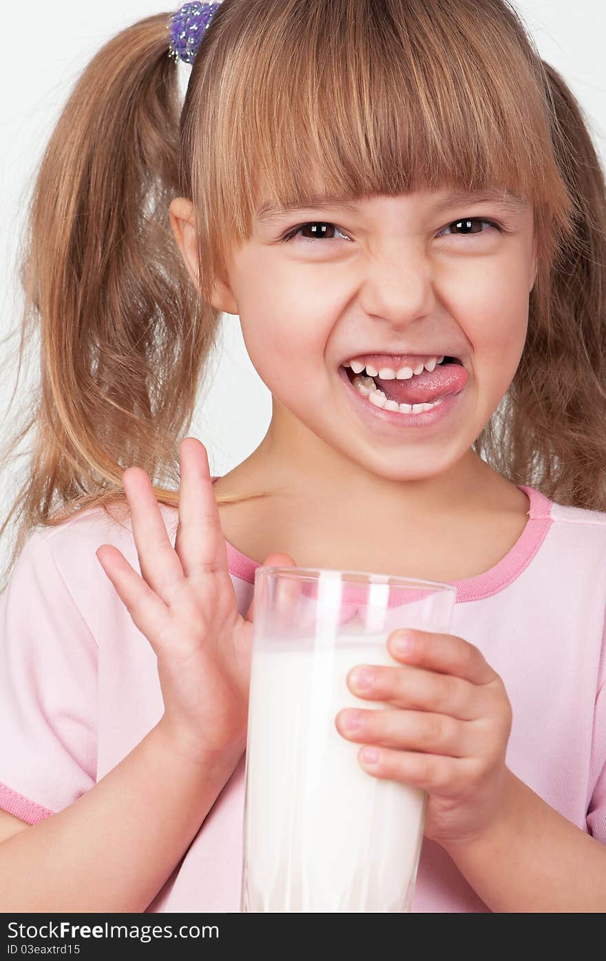 Cute little girl with glass of milk on light background. Cute little girl with glass of milk on light background