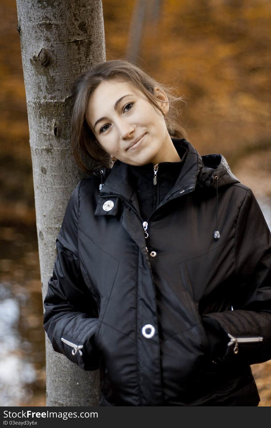 Portrait of pretty girl on a background of autumn forest