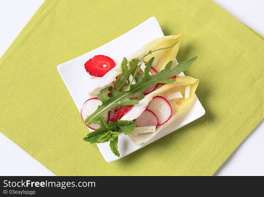 Endive and radish sprinkled with feta and rocket. Endive and radish sprinkled with feta and rocket