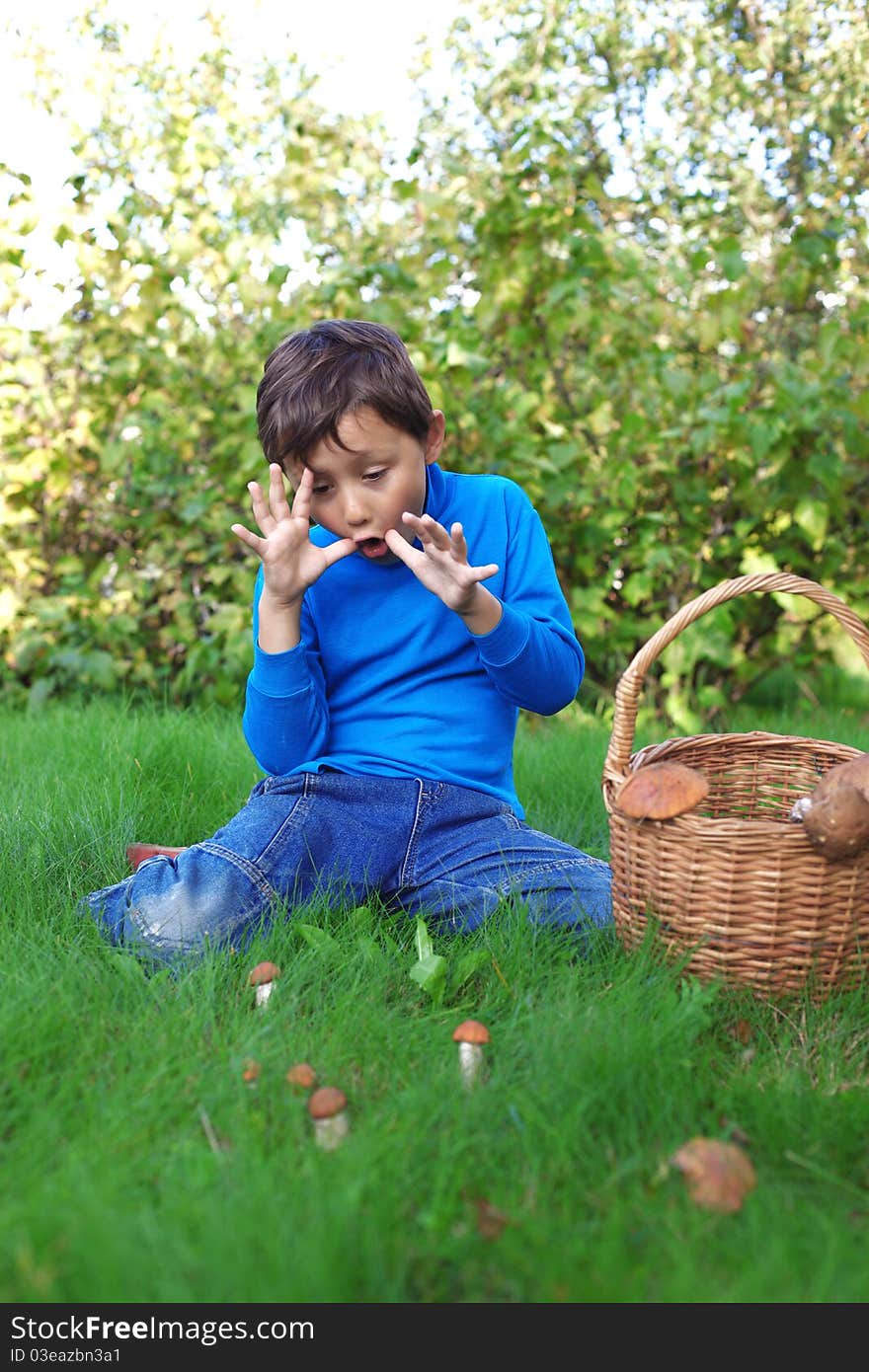 Little boy with mushrooms outdoors