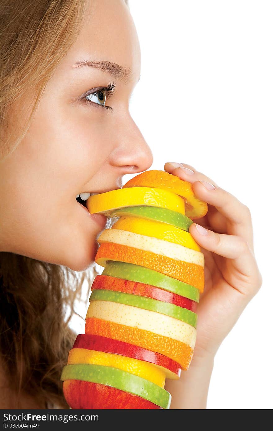 Portrait of happy young woman holding mixed fruits over white background