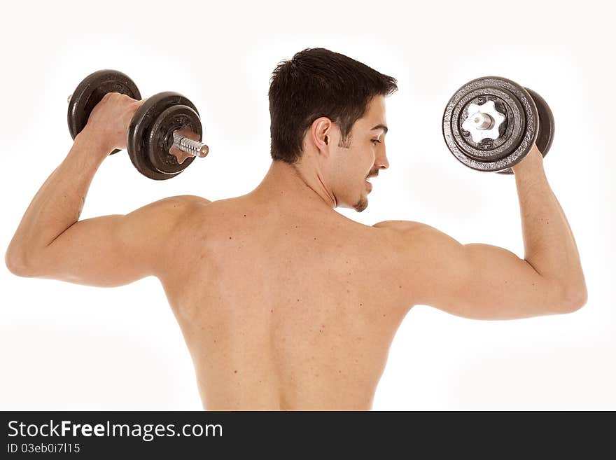 A man is working out with some weights.  View of his back. A man is working out with some weights.  View of his back.