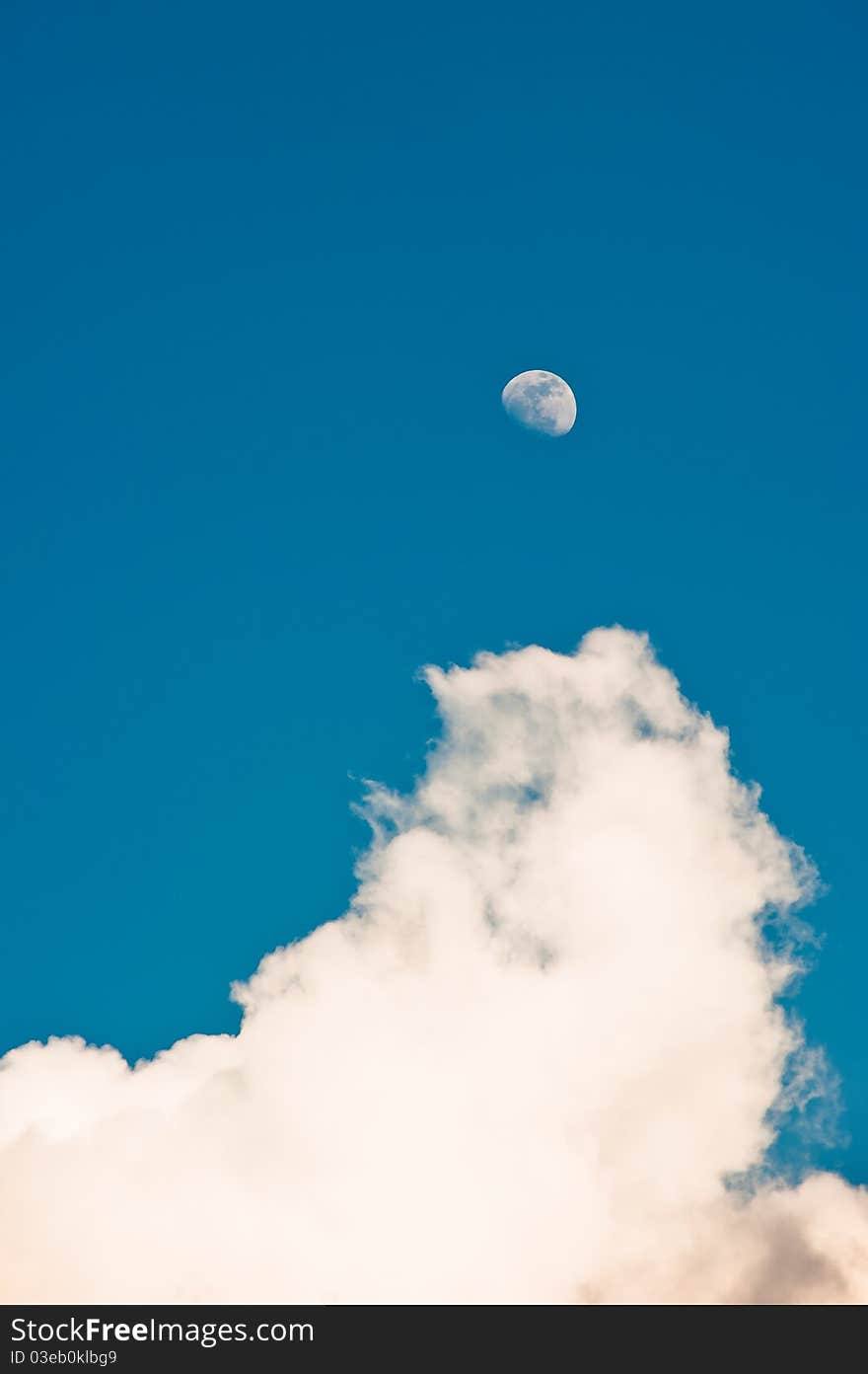 The moon and white clouds on blue sky