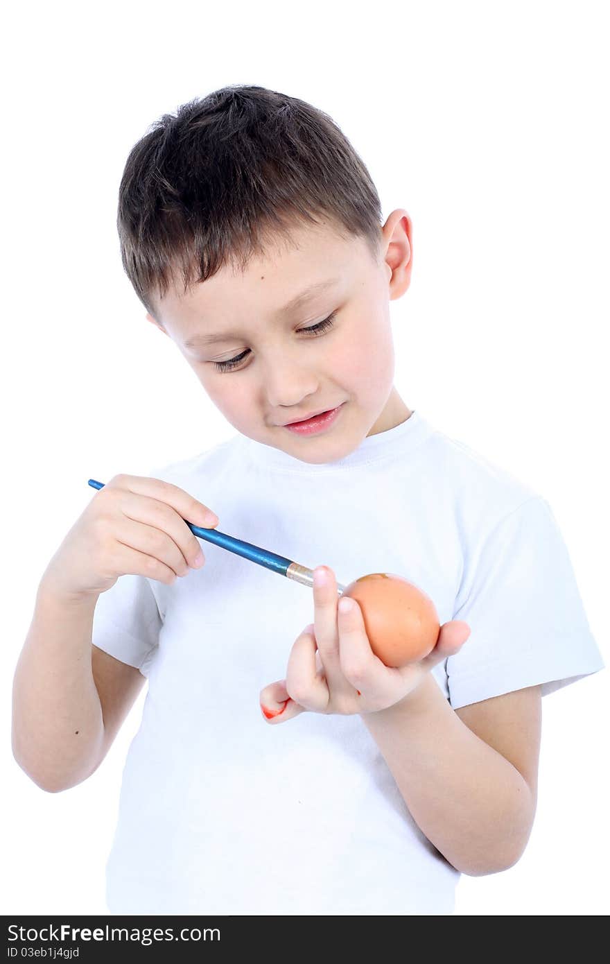 Little boy painting easter egg