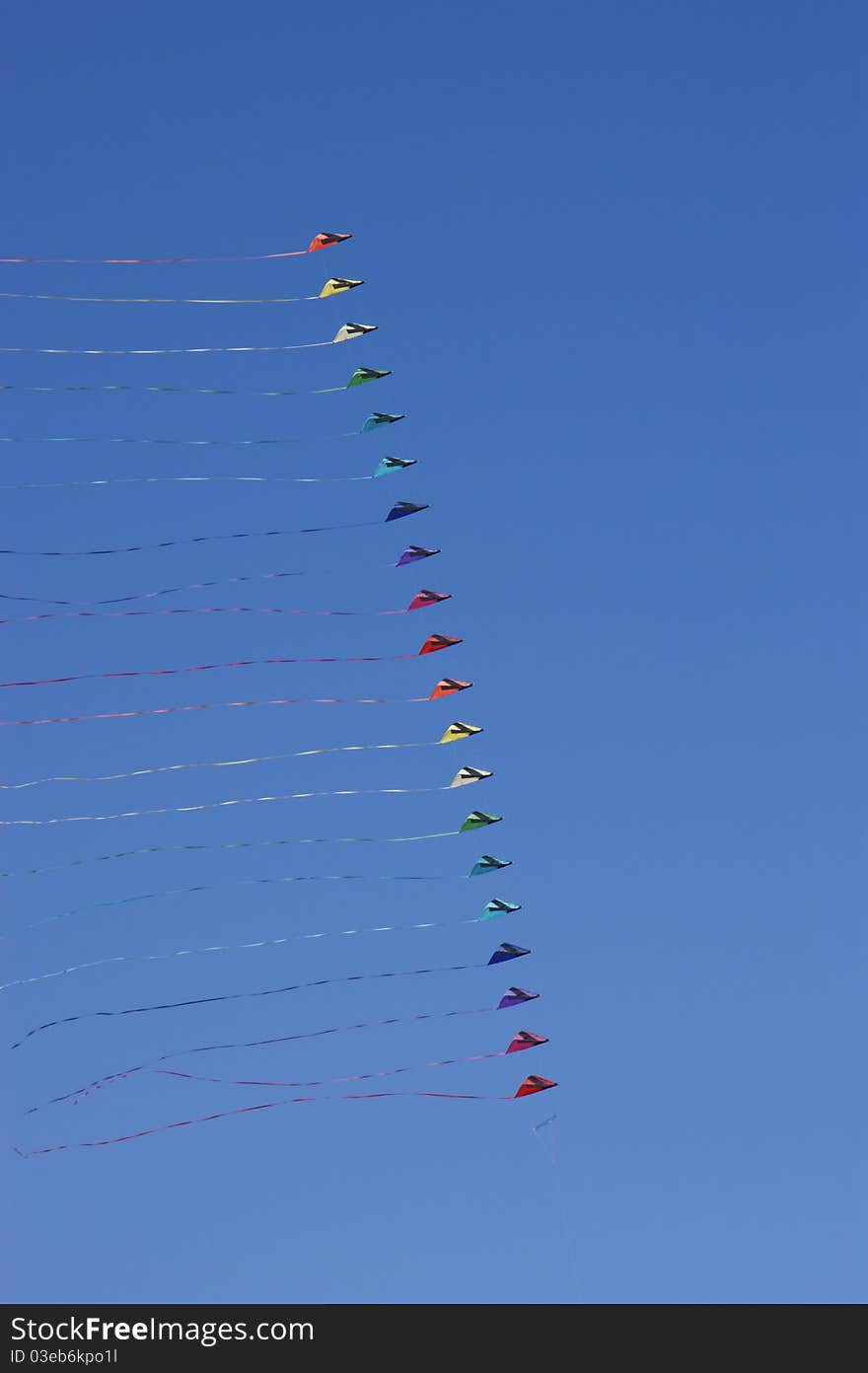 Colorful kites against a vivid blue sky