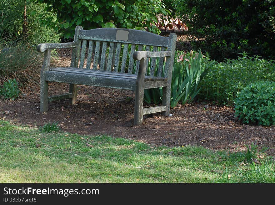 Worn bench in a city park. Worn bench in a city park