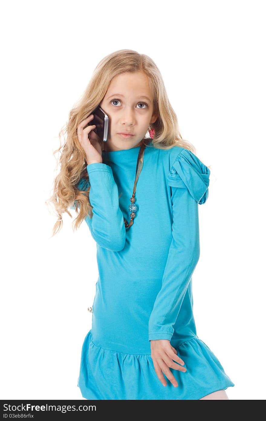 Young girl in blue dress talking by the phone. Young girl in blue dress talking by the phone