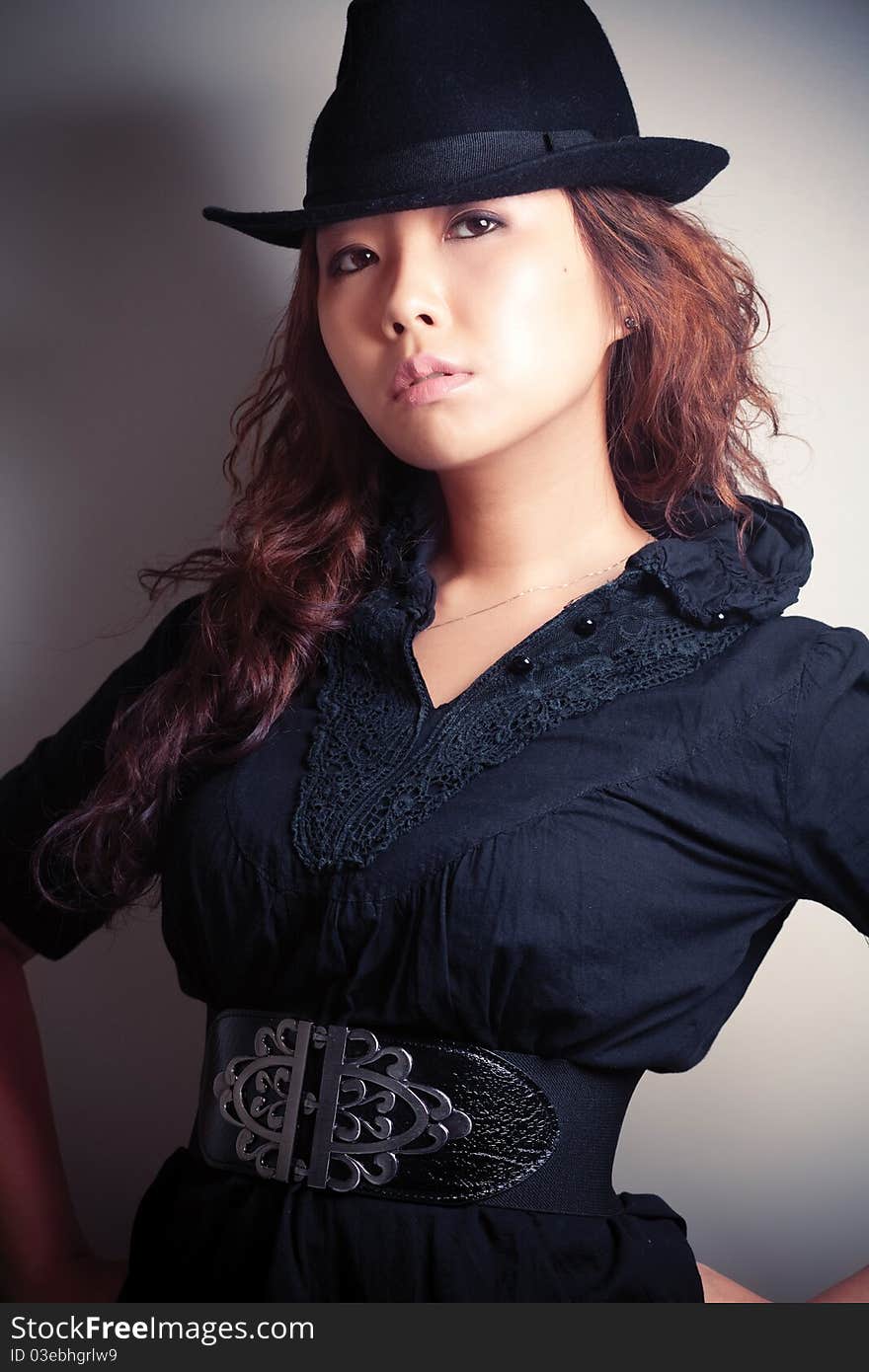 Asian young woman in black fashion shoot.