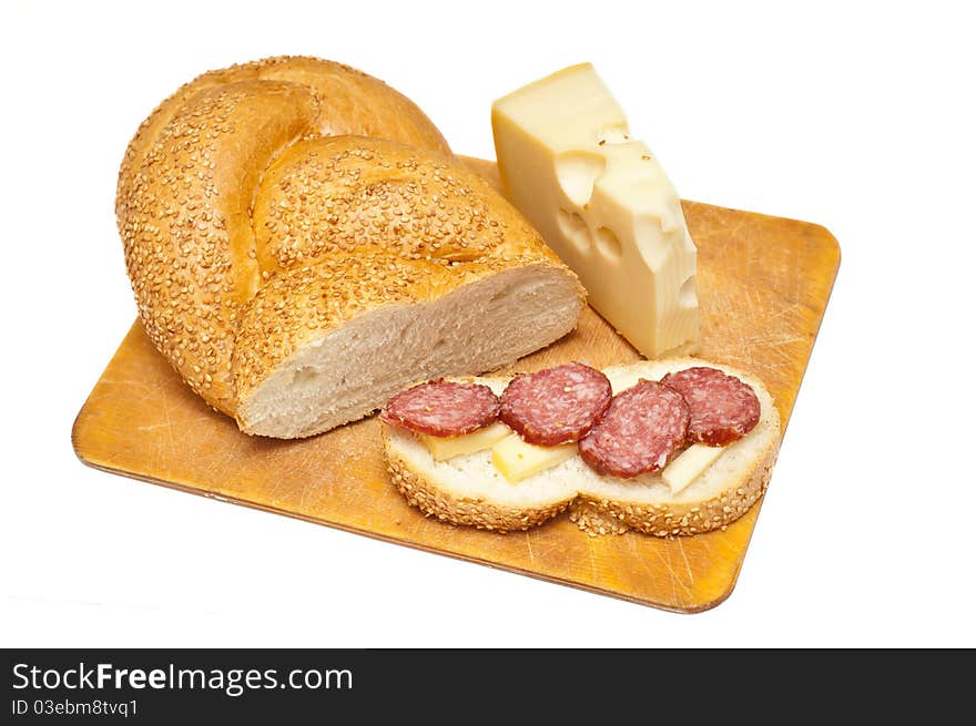 Sausage cheese and bread on a wooden board