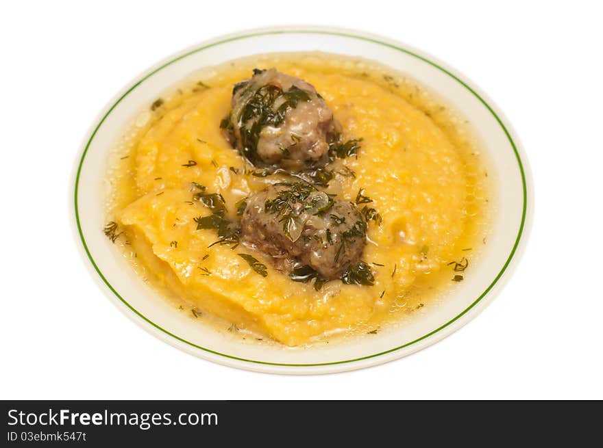 Mashed peas with meatballs against white background