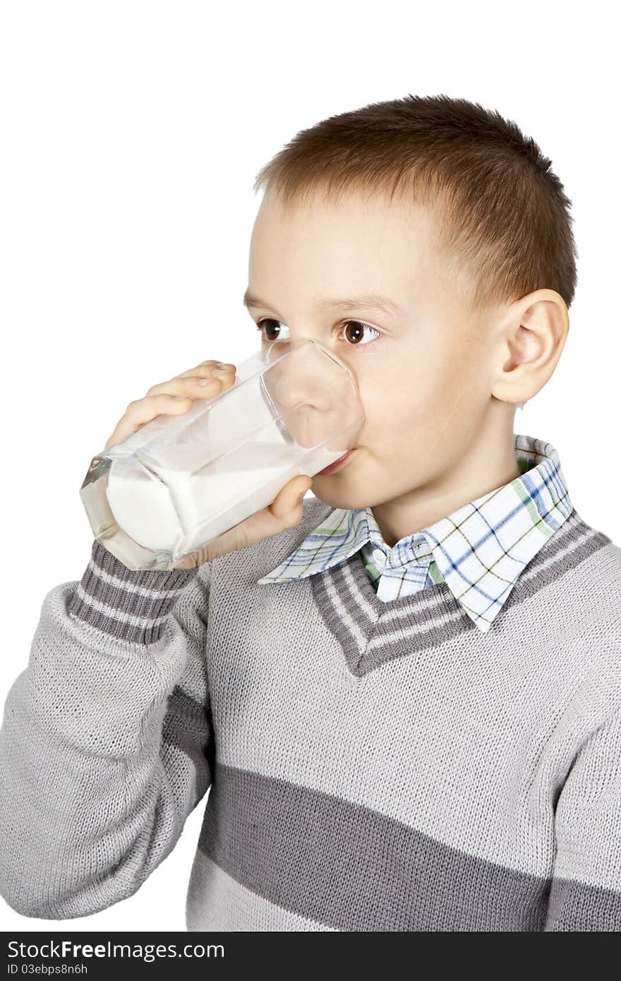 Boy drinking milk from a glass beaker on a white background. Boy drinking milk from a glass beaker on a white background.