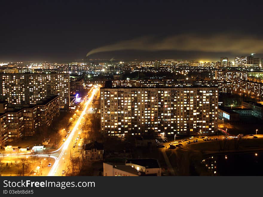 Landscape of a night city with a smoke from a pipe