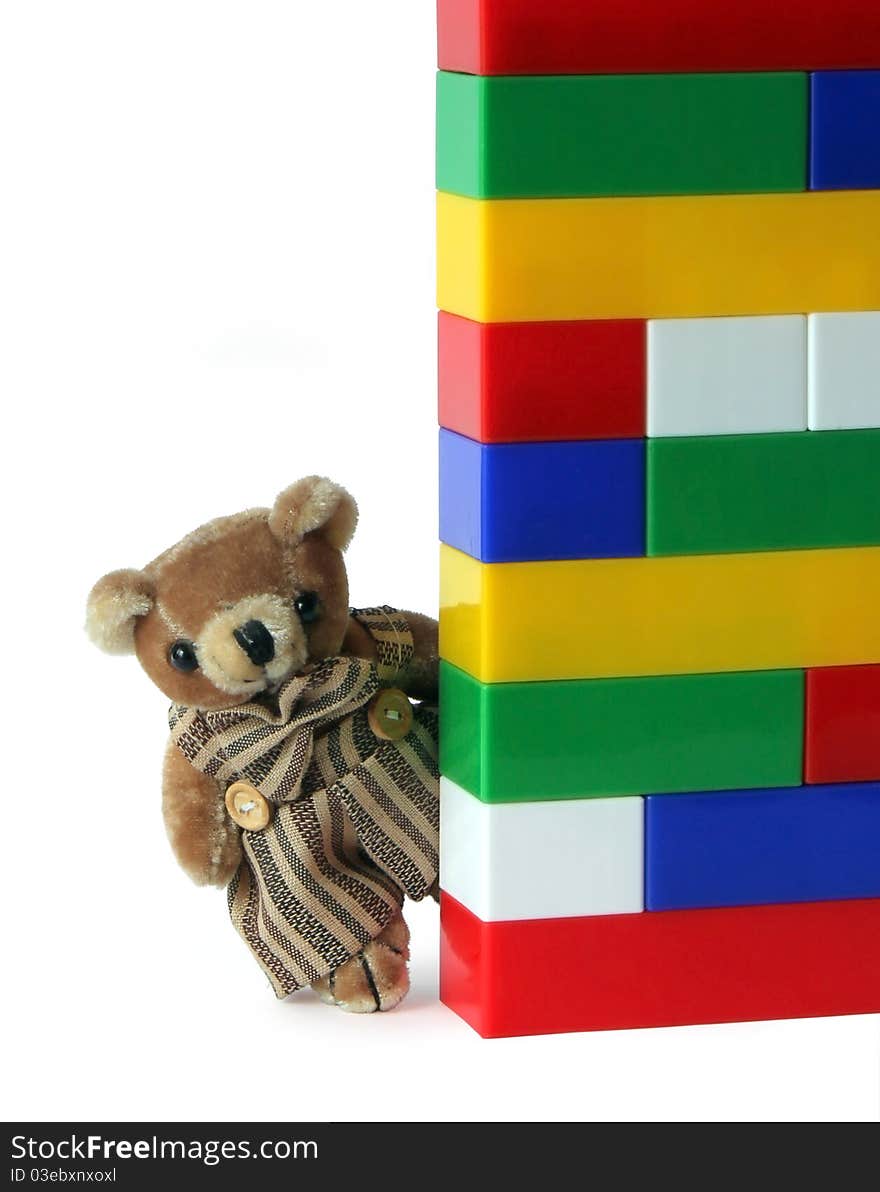 LittleTeddy Bear and stack of plastic motley bricks