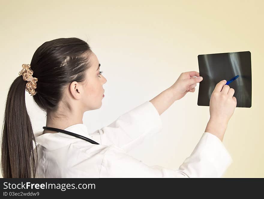 Young and nice doctor watching a patient x-ray