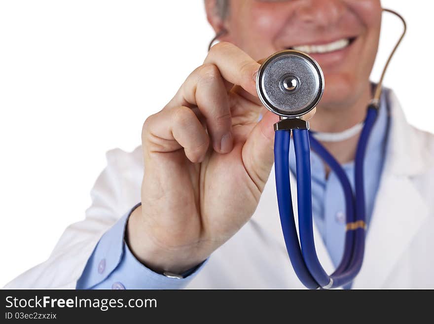 Close-up of a stethoscope,in background the smiling doctor.Isolated on white background. Close-up of a stethoscope,in background the smiling doctor.Isolated on white background.