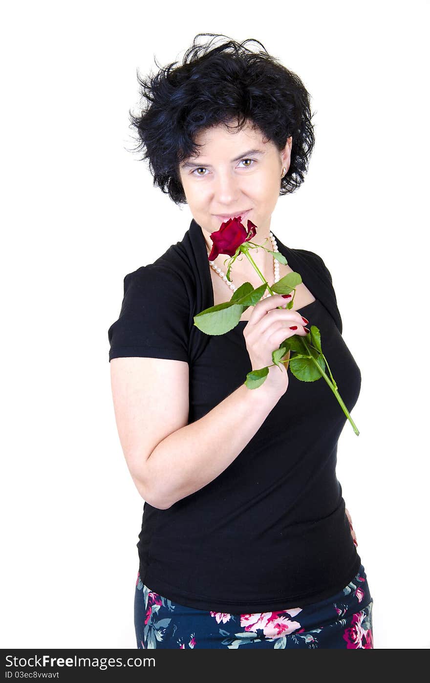 Woman in black blouse and colorful skirt with a red rose. Woman in black blouse and colorful skirt with a red rose