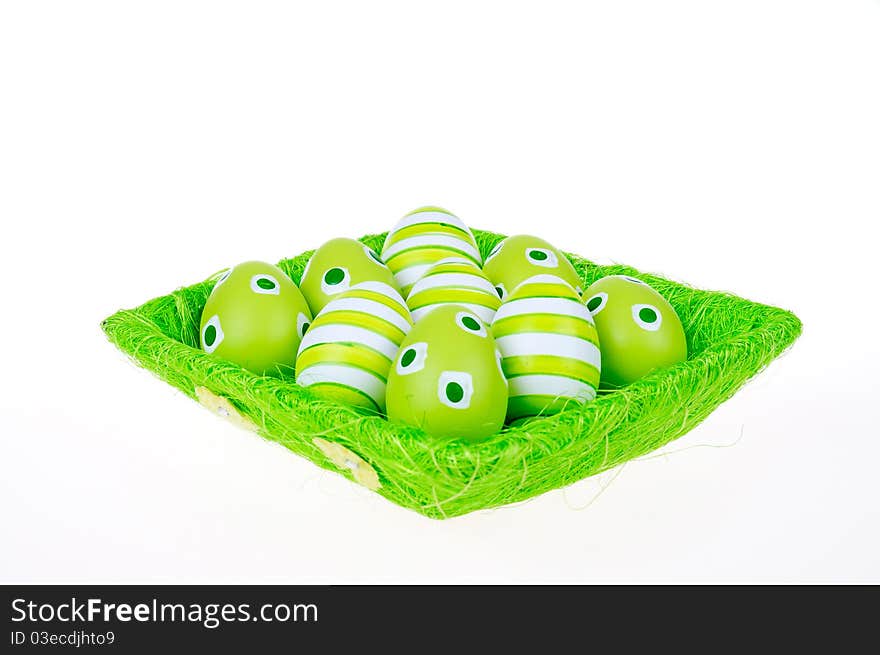 Eggs in the green Easter basket. Painted eggs