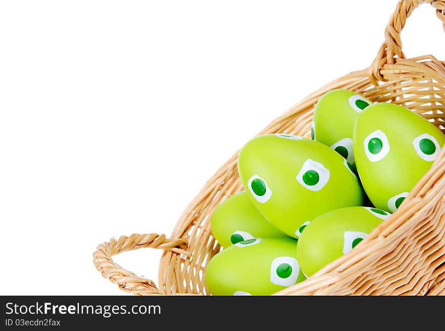 Eggs in the green Easter basket. Painted eggs