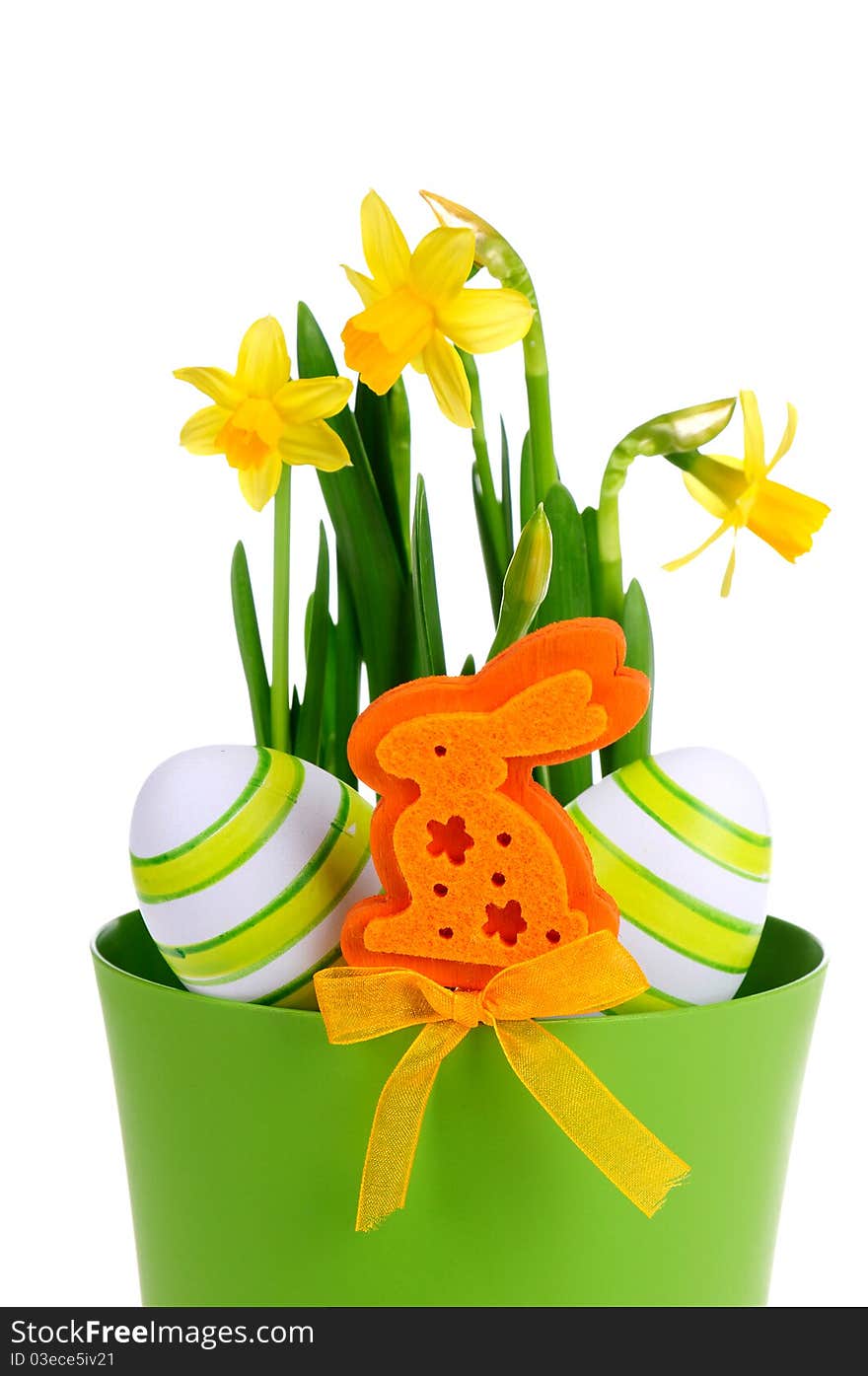 Painted easter egg and yellow daffodil on the green background.