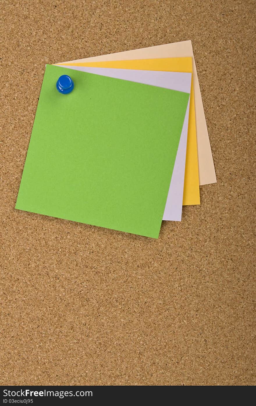 Four stacked blank notes pinned on the textured pin board