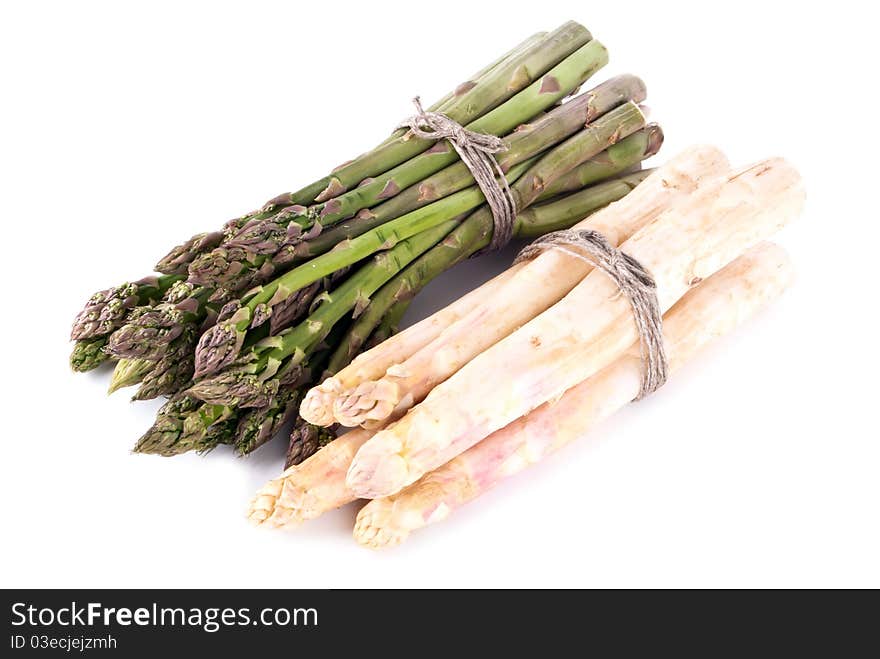 A bunch of green and white asparagus in front of white background