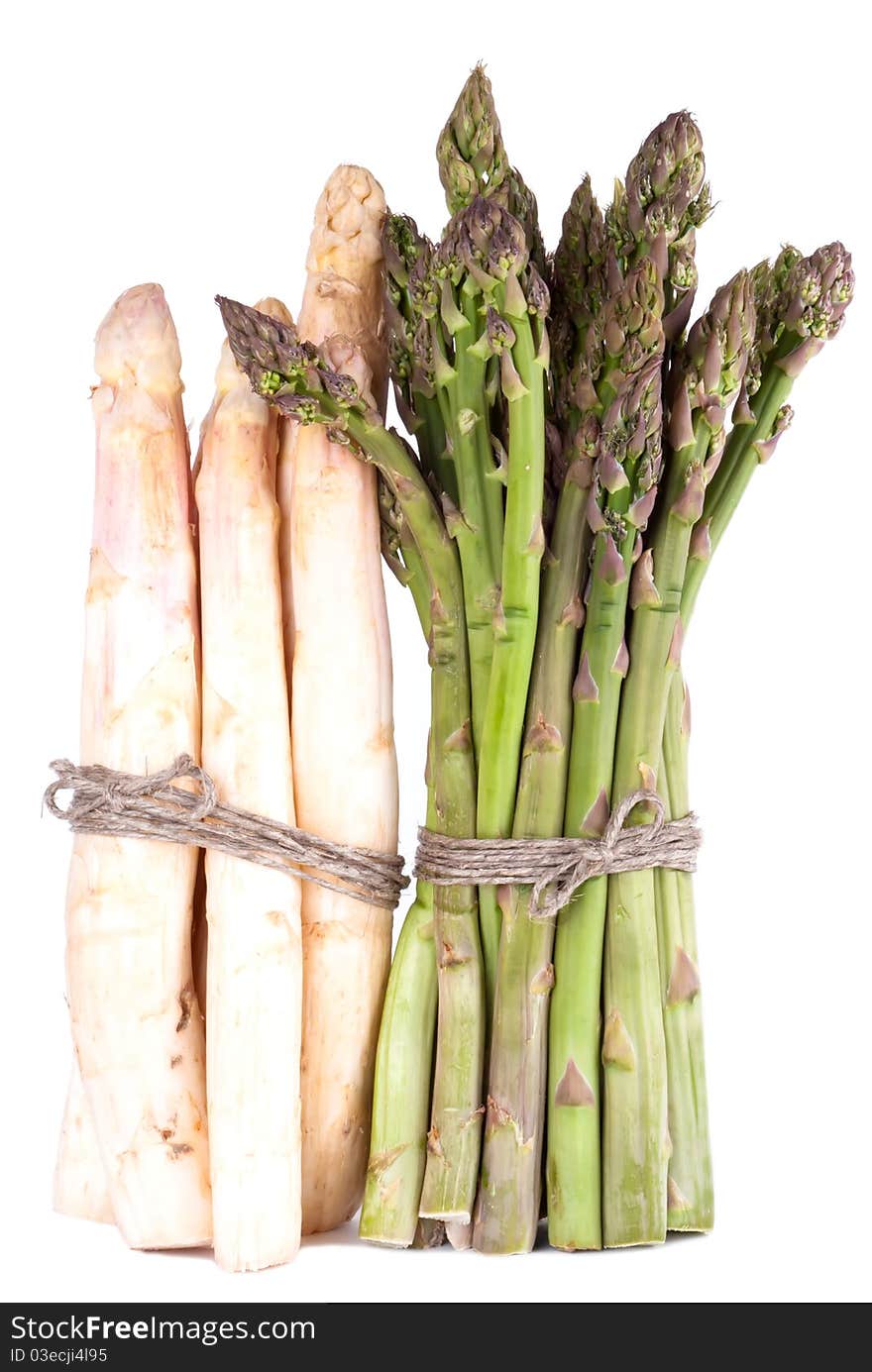 A bunch of green and white asparagus in front of white background