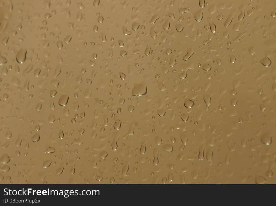 Background of water droplets on yellow reflective surface. Background of water droplets on yellow reflective surface