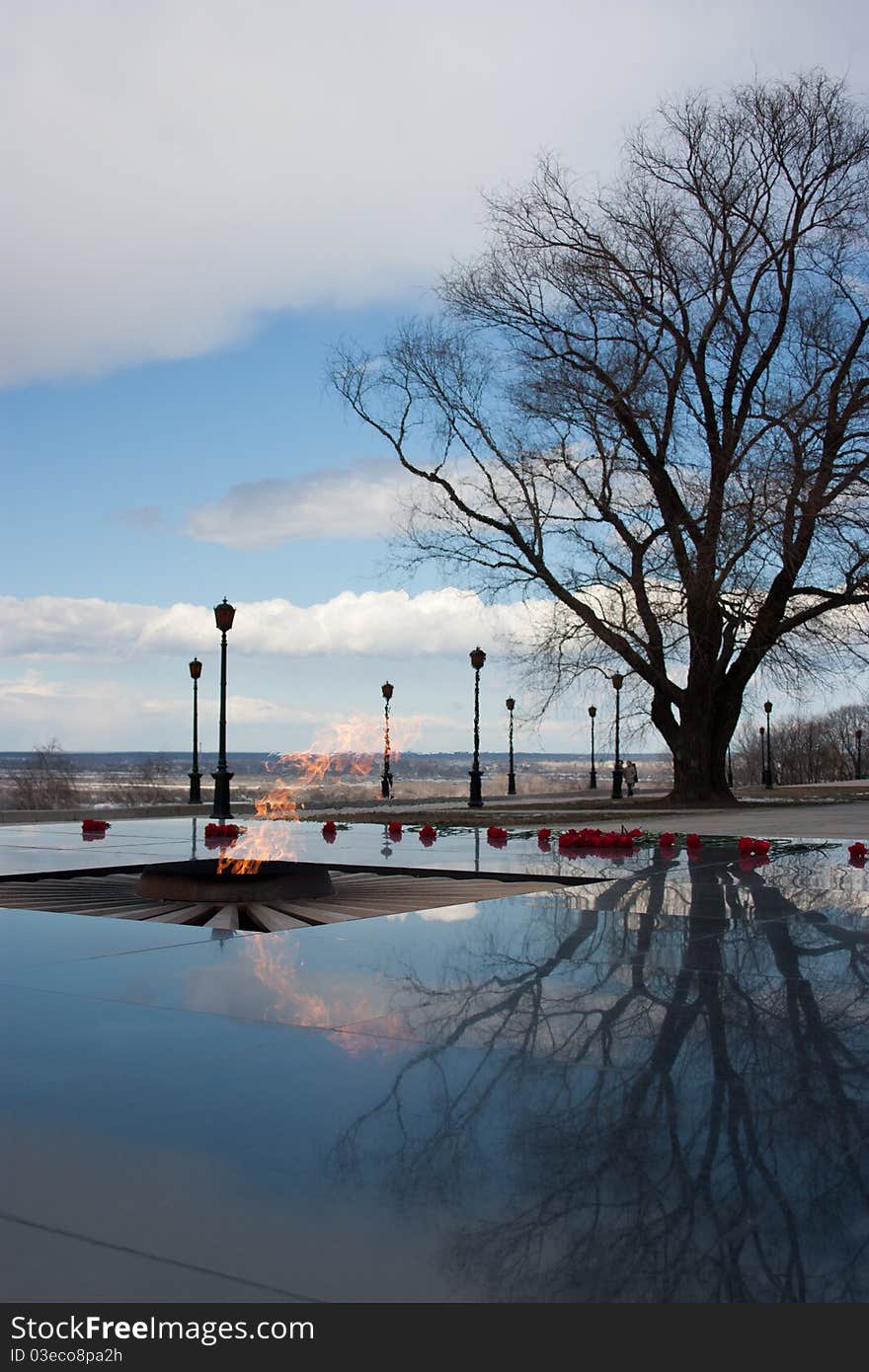 Memorial Eternal flame in Nizhni Novgorod against the spring sky and a tree