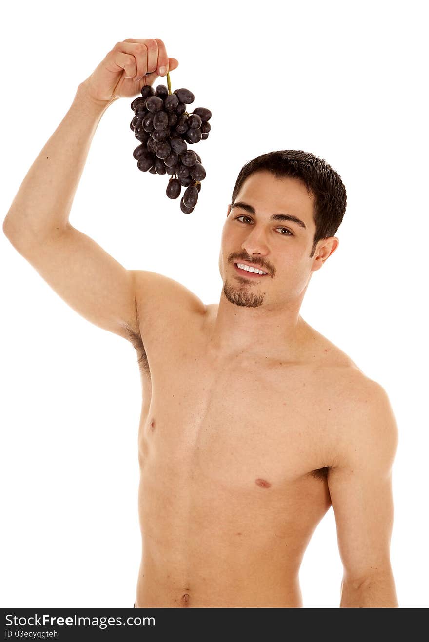 A man is holding up some grapes ready to eat them. A man is holding up some grapes ready to eat them.