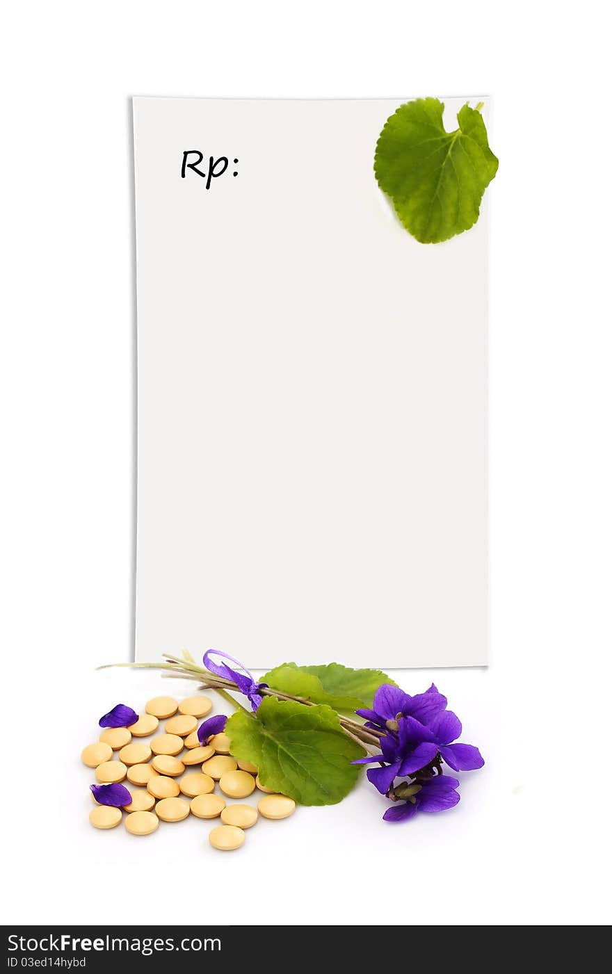 Herbal pills and flowers on a white background