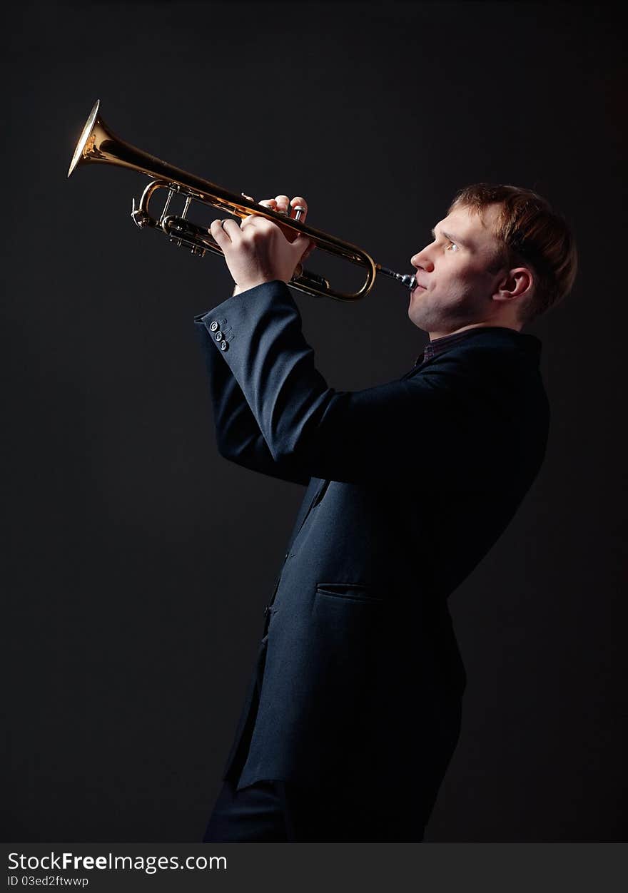 Portrait of a young man playing his Trumpet. Portrait of a young man playing his Trumpet