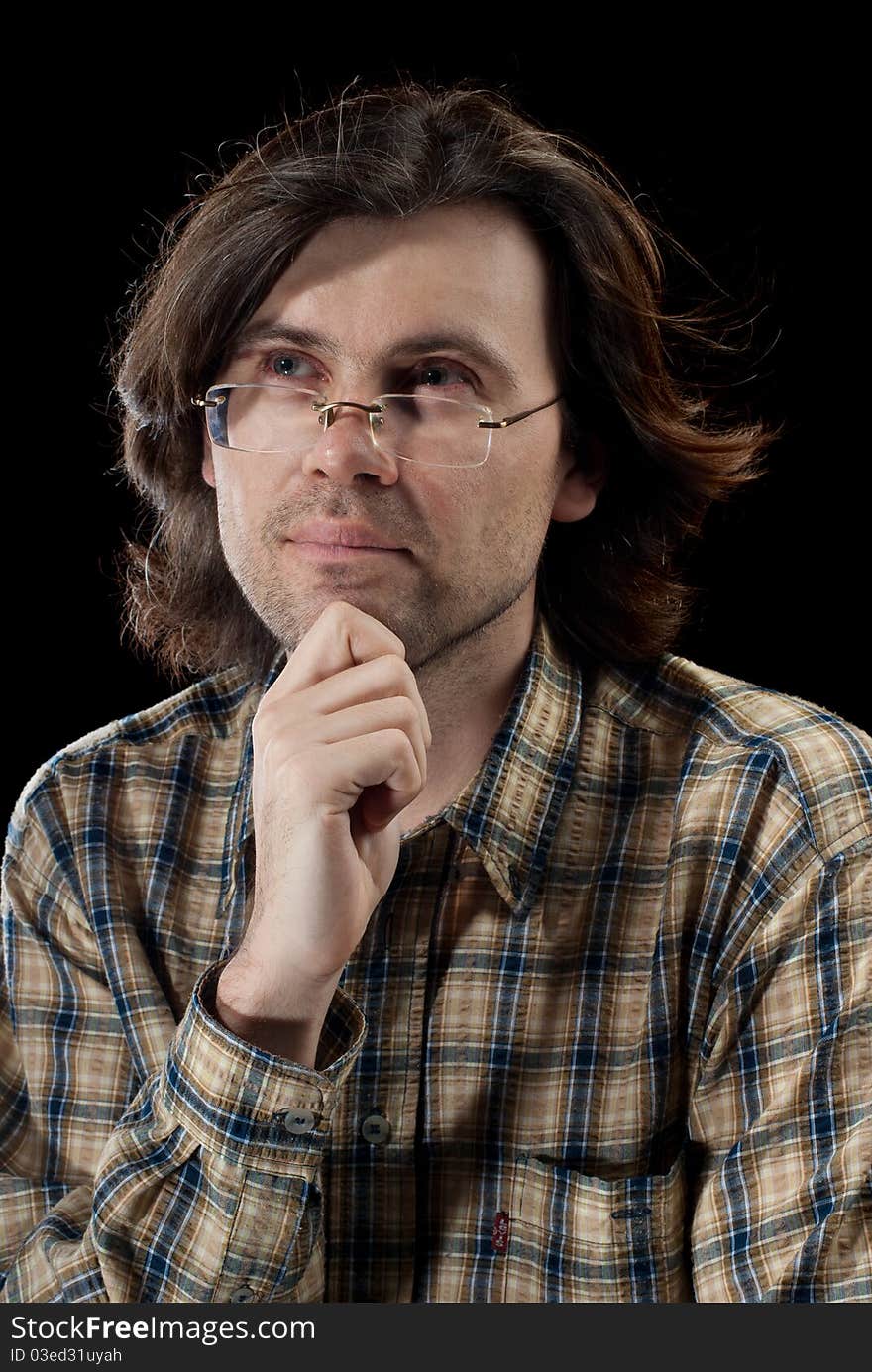 Portrait of handsome man with long hair. Isolated on black background.