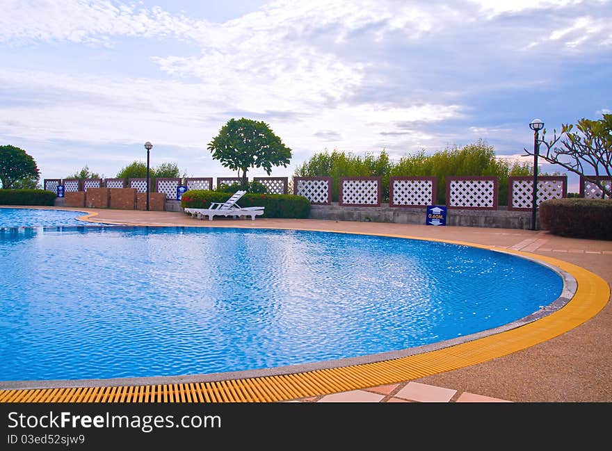 Wide Swimming pool in curve style with blue sky. Wide Swimming pool in curve style with blue sky